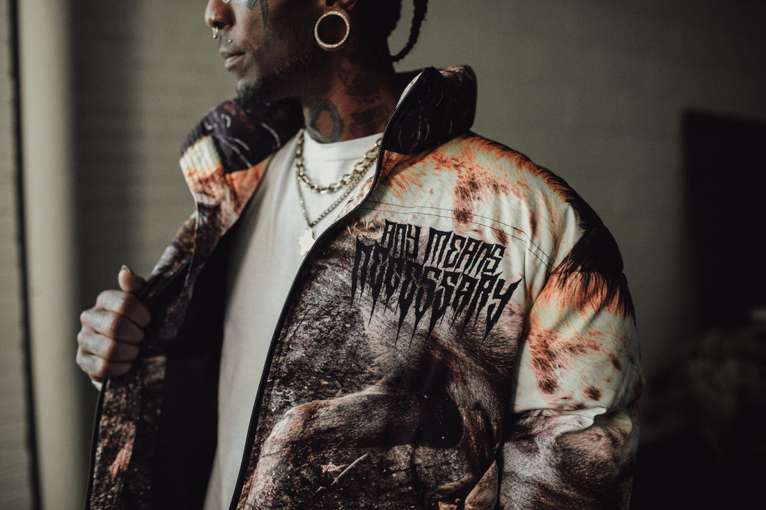 Last Stand puffer jacket by Any Means Necessary Clothing, featuring quilted design, high collar, and front zipper closure.