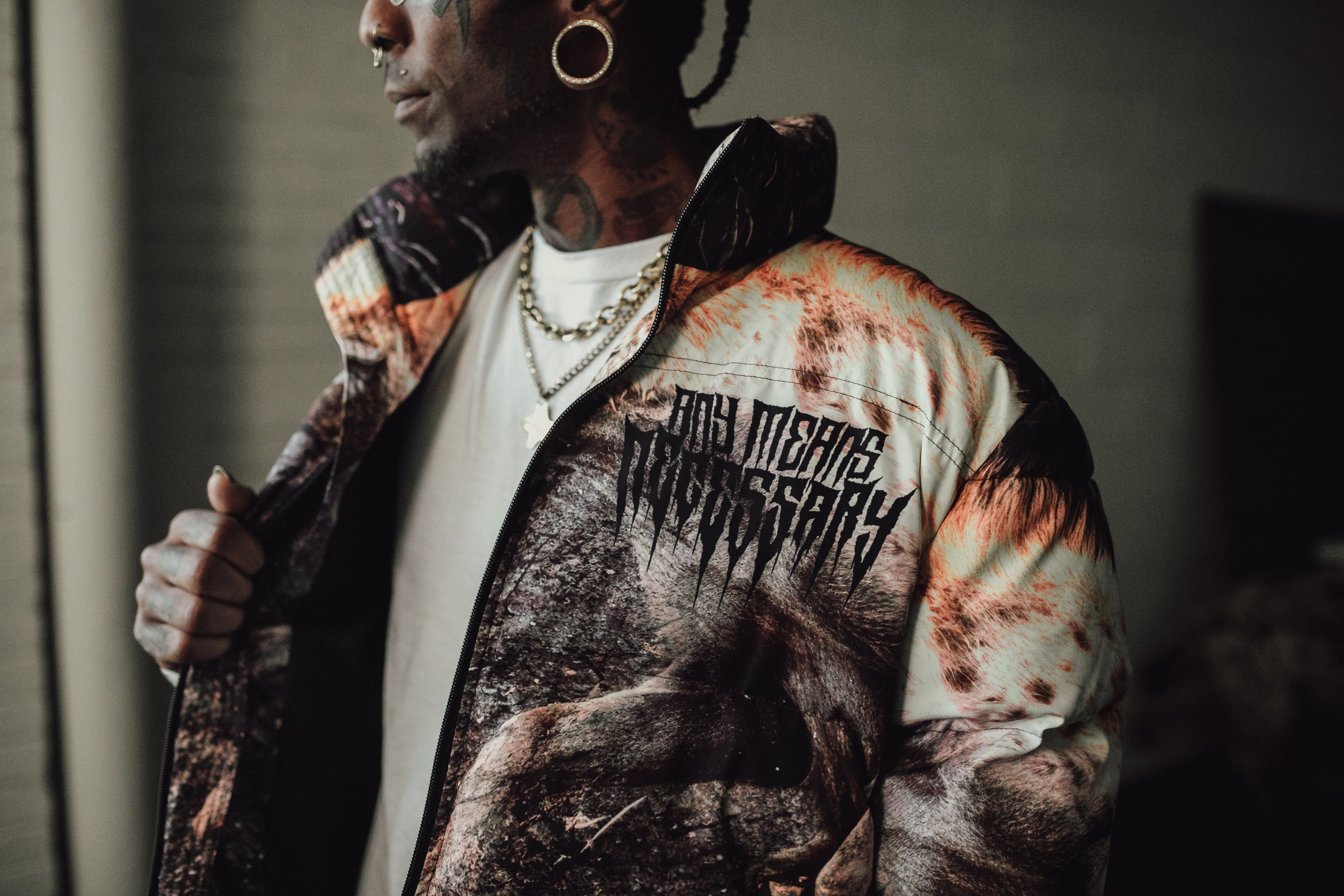Last Stand puffer jacket by Any Means Necessary Clothing, featuring quilted design, high collar, and front zipper closure.