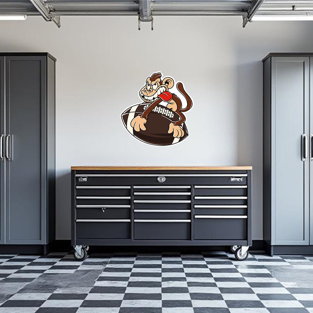 Decorative garage wall decal featuring a playful monkey and football design by Armed American Supply.