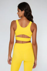 Yellow Breathe Easy Cut-Out Back Sports Bra by Fitkitty Culture featuring a Lycra® blend and stylish cut-out design for activewear.