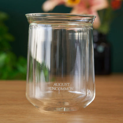 Elegant tasting glass from August Uncommon Tea, designed for refined tea-drinking experiences, with a clear, smooth glass surface.