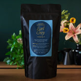 Bag of August Uncommon Tea Essentials Earl Grey Black Tea, 70-count, with tea bags and packaging visible.