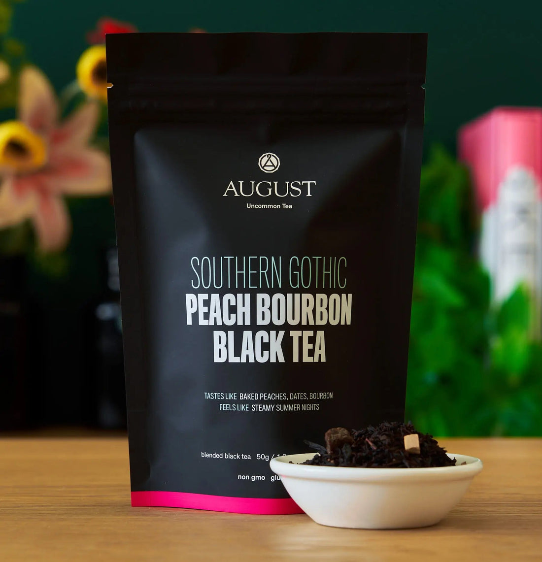 Box of August Uncommon Tea Southern Gothic Peach Bourbon Black Tea in a 15-cup bag, showcasing black tea leaves and packaging.