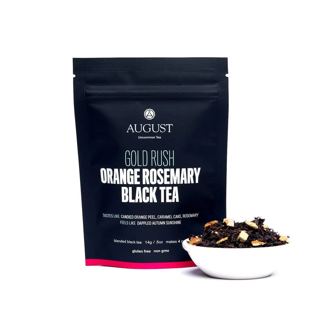 Golden-orange rosemary caramel black tea in a cup, showcasing rich color and aromatic details of August Uncommon Tea&