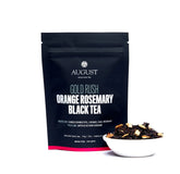 Golden-orange rosemary caramel black tea in a cup, showcasing rich color and aromatic details of August Uncommon Tea&