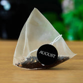 Jet Black Roasty Coffee Black Tea by August Uncommon Tea, 15 tea bags in a box with black and gold packaging.