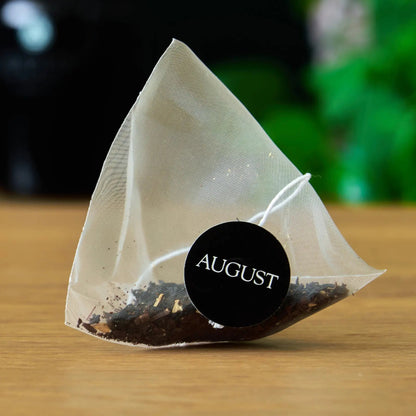 Jet Black Roasty Coffee Black Tea by August Uncommon Tea, 15 tea bags in a box with black and gold packaging.