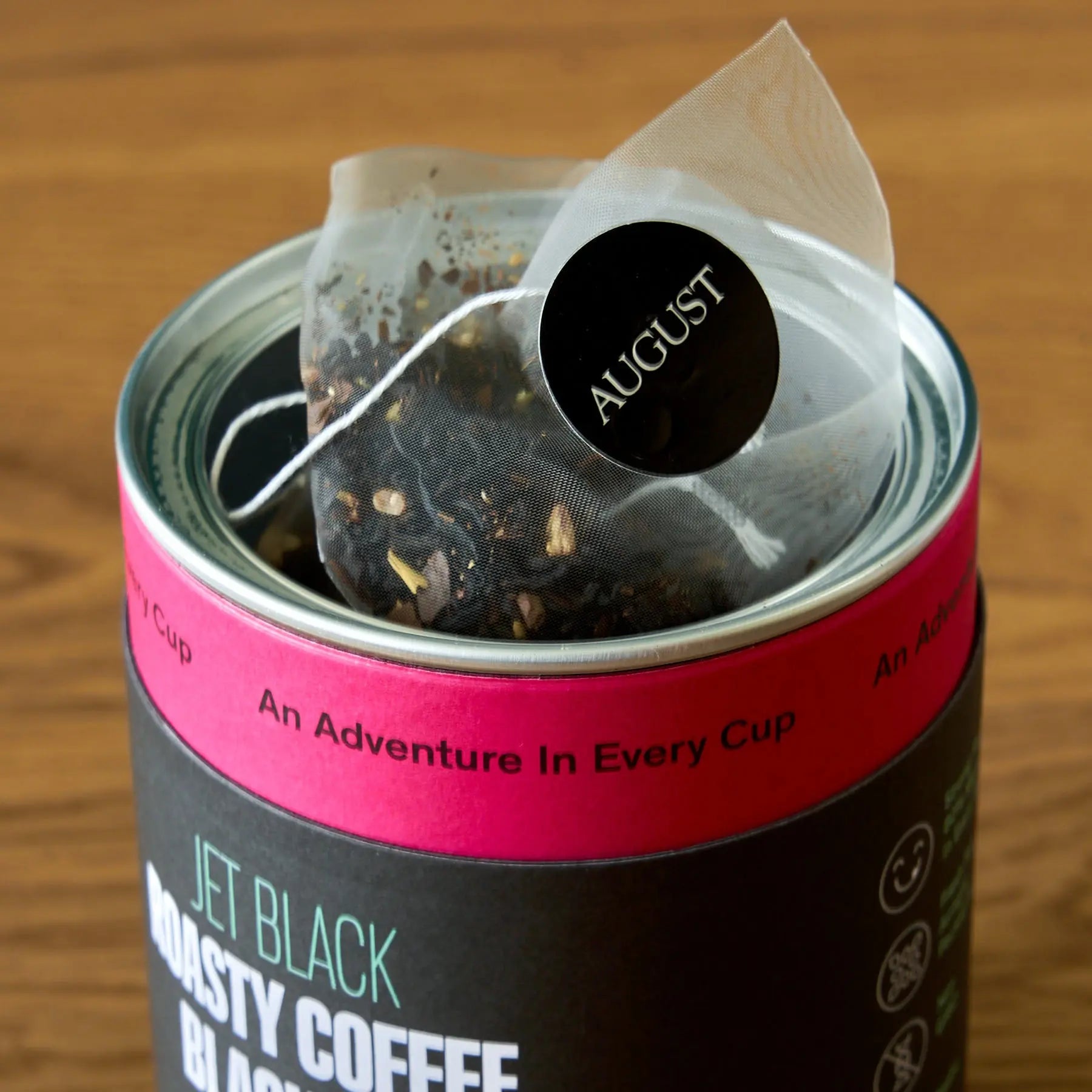 Jet Black Roasty Coffee Black Tea by August Uncommon Tea, 15 tea bags in a box, showcasing black tea leaves and packaging.