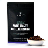Herbal tea bag labeled Daybreak Sweet Roasted Coffee Alternative by August Uncommon Tea, caffeine-free beverage for tea lovers.