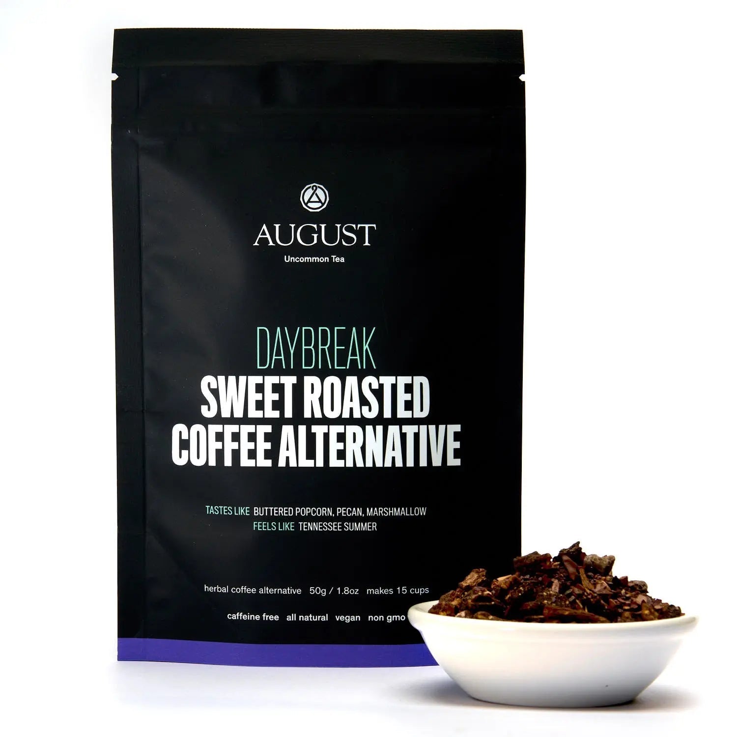 Herbal tea bag labeled Daybreak Sweet Roasted Coffee Alternative by August Uncommon Tea, caffeine-free beverage for tea lovers.