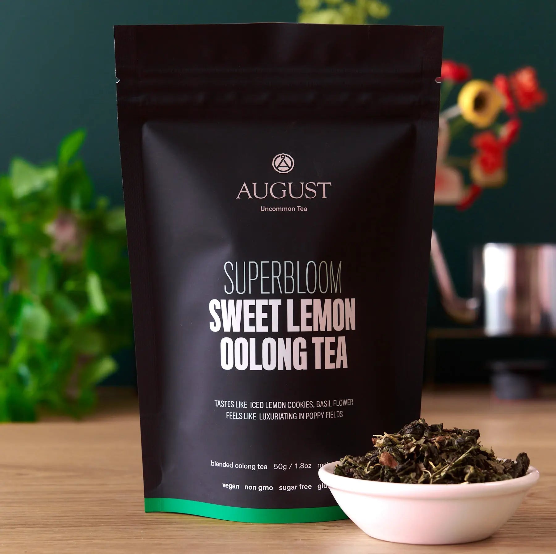 Box of August Uncommon Tea Superbloom Sweet Lemon Oolong Green Tea with 15 tea bags, showcasing fresh lemon slices and green tea leaves.