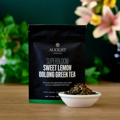 Bag of August Uncommon Tea Superbloom Sweet Lemon Oolong Green Tea, featuring fresh lemon flavor in a 15-cup brew-ready bag.