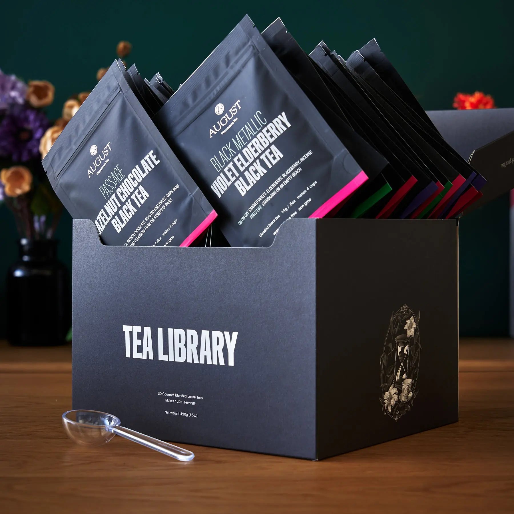 August Uncommon Tea Deluxe 30 Tea Sampler featuring a variety of loose leaf teas in a elegant packaging.