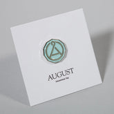 August Seal enamel pin featuring a colorful seal design, perfect as swag from August Uncommon Tea.