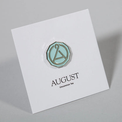 August Seal enamel pin featuring a colorful seal design, perfect as swag from August Uncommon Tea.