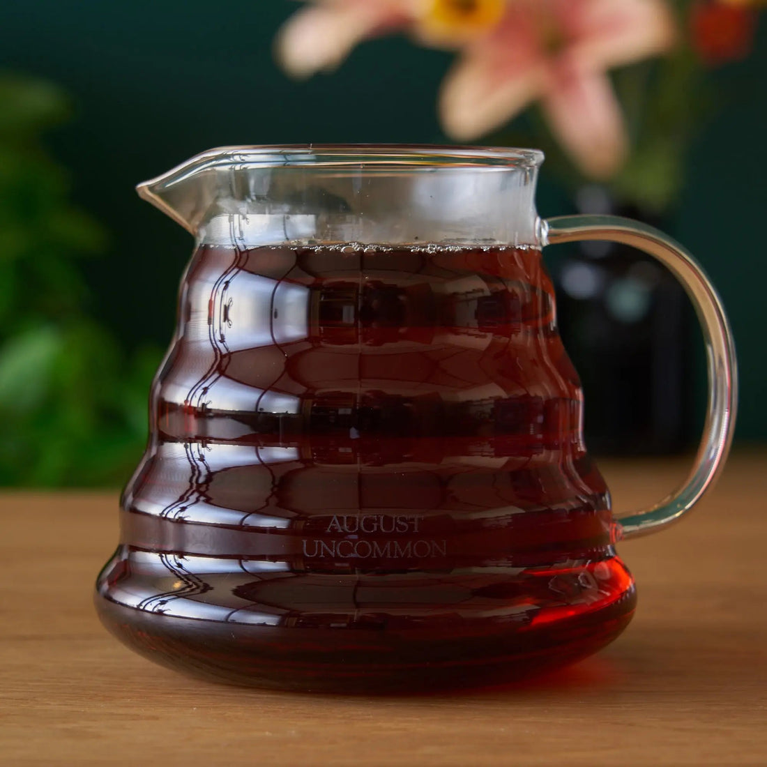 Two cup glass teapot by August Uncommon Tea, clear teaware with a simple design, perfect for brewing and serving tea.