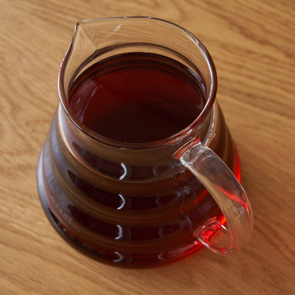 Two cup glass teapot by August Uncommon Tea, transparent teaware for brewing and serving tea, showcasing its clear glass design.