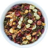 Herbal tea by August Uncommon Tea featuring honeydew melon and mint in a clear glass cup, caffeine-free beverage.