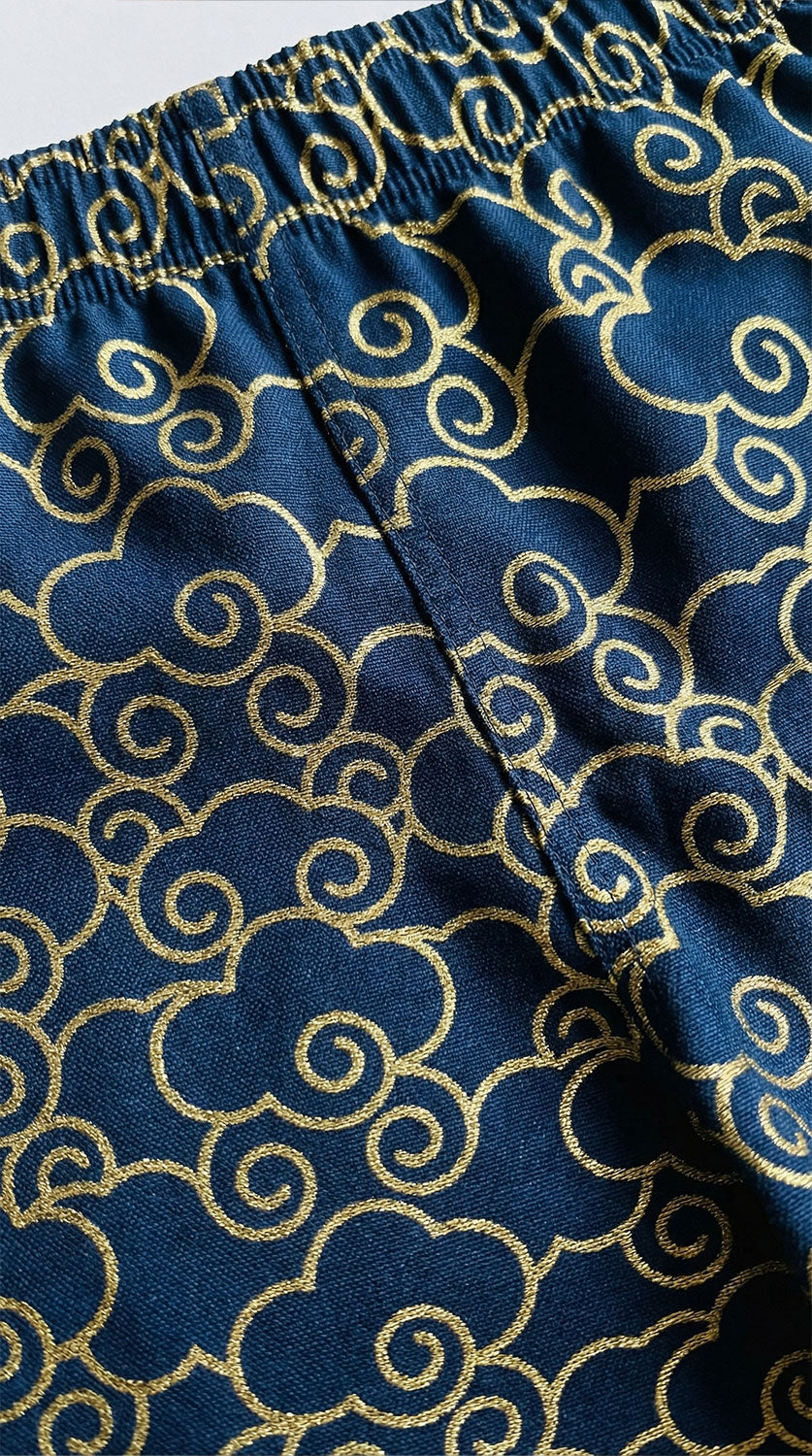Yūjin Clothing Japanese Clouds swim trunks featuring a vibrant cloud pattern on lightweight, quick-drying fabric for beach or pool.