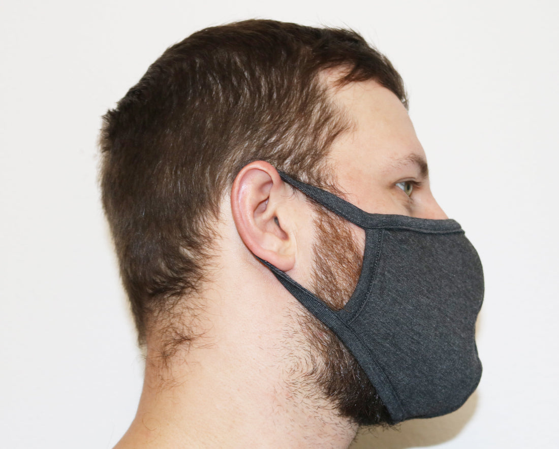 Large Spun Bamboo triple-layer breathable face mask in natural color, showing its soft, comfortable fabric and design for face coverage.