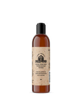 Organic hand-whipped Johnny Slicks beard wash in a clear bottle, showcasing a creamy, natural beard cleansing product.