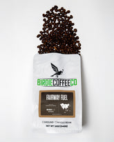 Ground medium roast Fairway Fuel coffee by Birdie Coffee Company, showcasing rich, freshly brewed coffee grounds in a clear container.