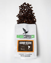 Ground Fairway Reserve Colombia Coffee by Birdie Coffee Company in a clear bag, showcasing rich roasted coffee grounds.