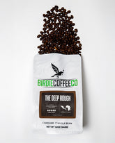 Ground Dark Roast Coffee from Birdie Coffee Company, The Deep Rough, with rich, deep-brewed coffee grounds in a bag.