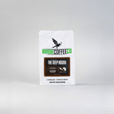 Ground dark roast coffee from Birdie Coffee Company, The Deep Rough, with rich, deep brown coffee grounds in a close-up shot.