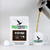 Ground dark roast coffee from Birdie Coffee Company, The Deep Rough, with rich, aromatic coffee grounds for brewing.