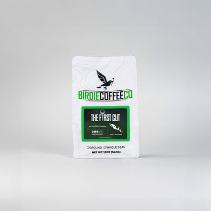 Medium roast coffee from Birdie Coffee Company, The First Cut, displayed in a clear glass mug with a rich, aromatic brew inside.