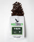 Decaf coffee bag labeled The Mulligan from Birdie Coffee Company, featuring a rustic coffee bag with branding and label details.