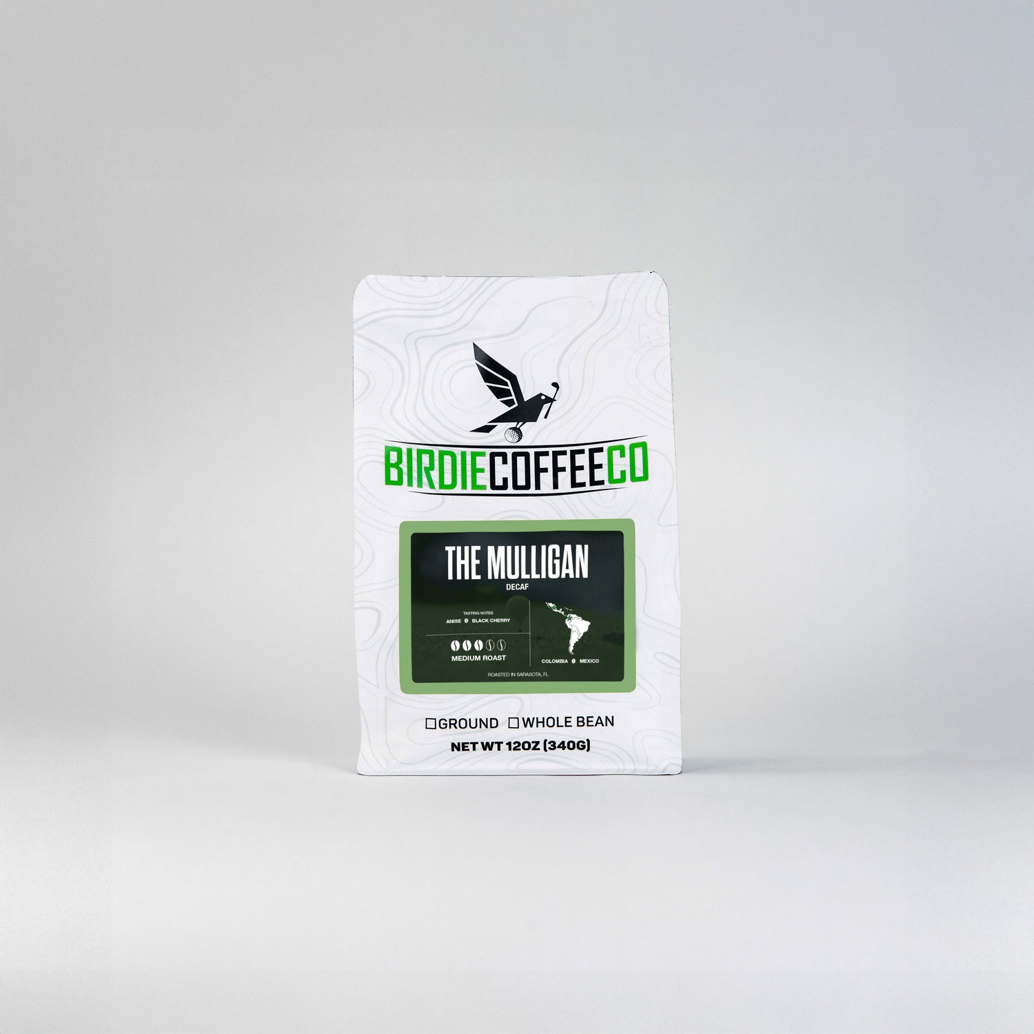 Decaf coffee bag labeled The Mulligan from Birdie Coffee Company, featuring a modern design and dark roasted beans.