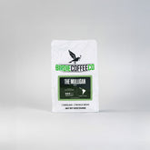 Ground decaf coffee from Birdie Coffee Company, The Mulligan blend, shown in a close-up image of the coffee grounds.