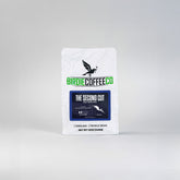 Ground Birdie Coffee Company The Second Cut Light Roast Coffee in a clear bag showing the light-colored coffee grounds.