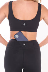 Black HydroFlex Cut Out Leggings by White Water Life featuring mesh panels and a sleek, athletic fit for active wear.