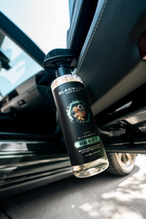 Blackline Car Care BLACKLINE® RESET interior cleaner and scent booster bottle close-up showing branding and product details.