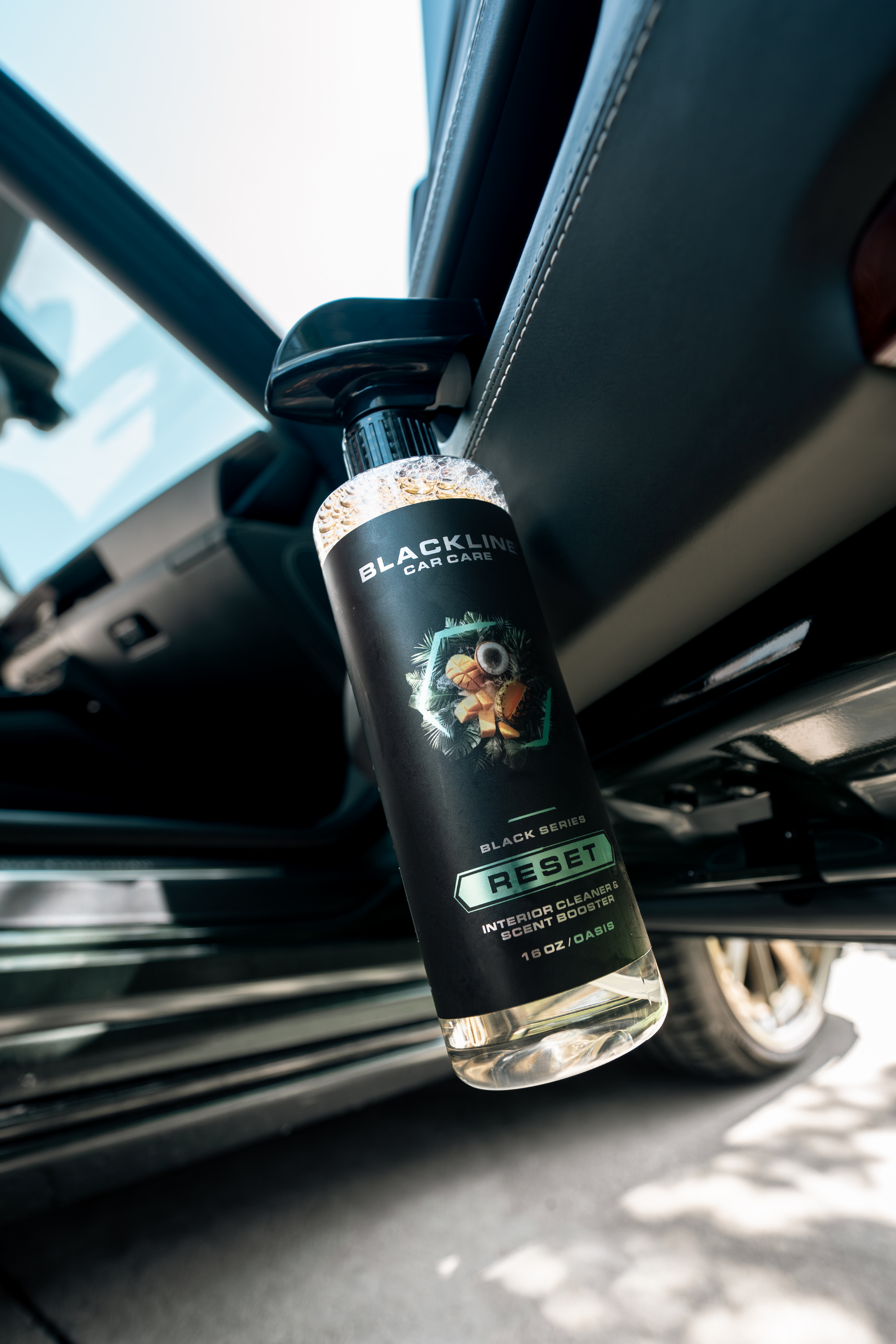 Blackline Car Care BLACKLINE® RESET interior cleaner and scent booster bottle close-up showing branding and product details.