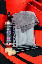 Blackline Car Care BLACKLINE® Reset interior cleaner and scent booster in a Ferrari F12 seat, showcasing the complete system.
