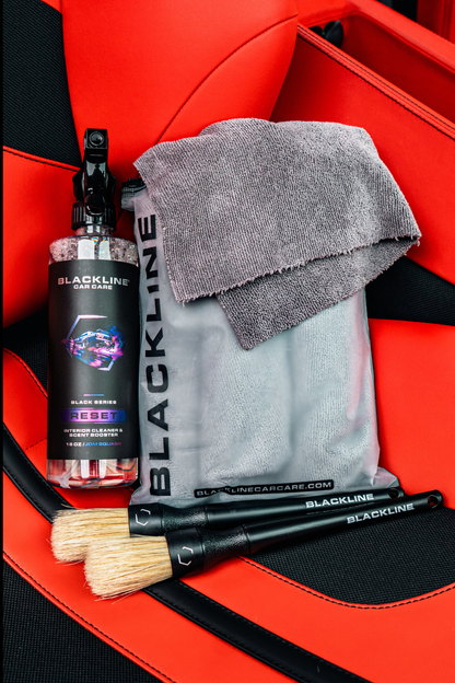 Blackline Car Care BLACKLINE® Reset interior cleaner and scent booster in a Ferrari F12 seat, showcasing the complete system.