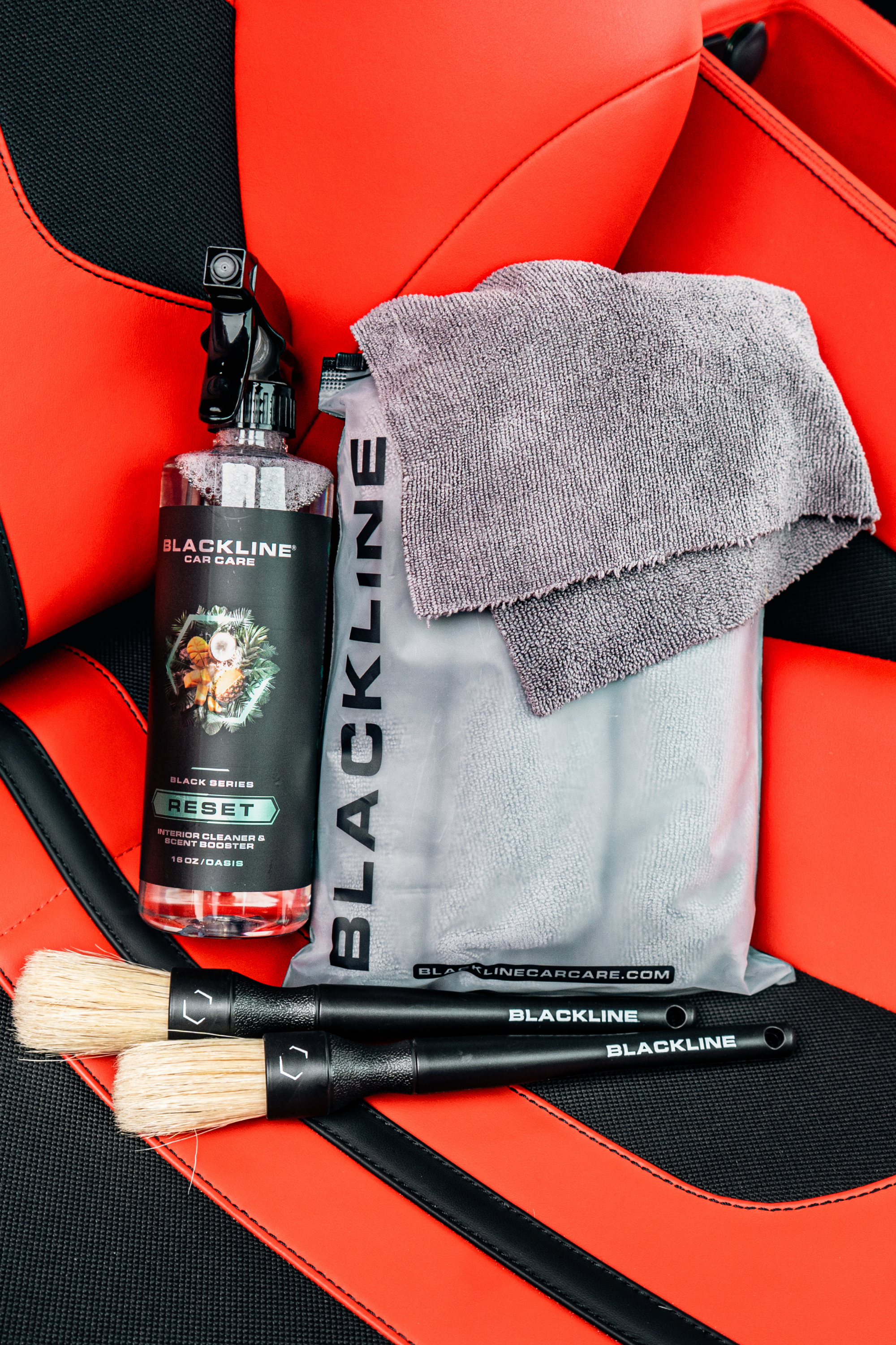 Blackline Car Care BLACKLINE® RESET Interior Cleaner and Scent Booster on Ferrari F12 seat, showcasing clean interior and fresh scent.