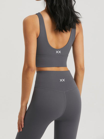 BLACKOUT BARBELL Omni Bra in dark gray, featuring supportive straps and seamless design for comfortable activewear.