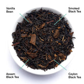 Bowl of smoky vanilla black tea leaves from August Uncommon Tea, showcasing dark, aromatic tea leaves for breakfast brewing.