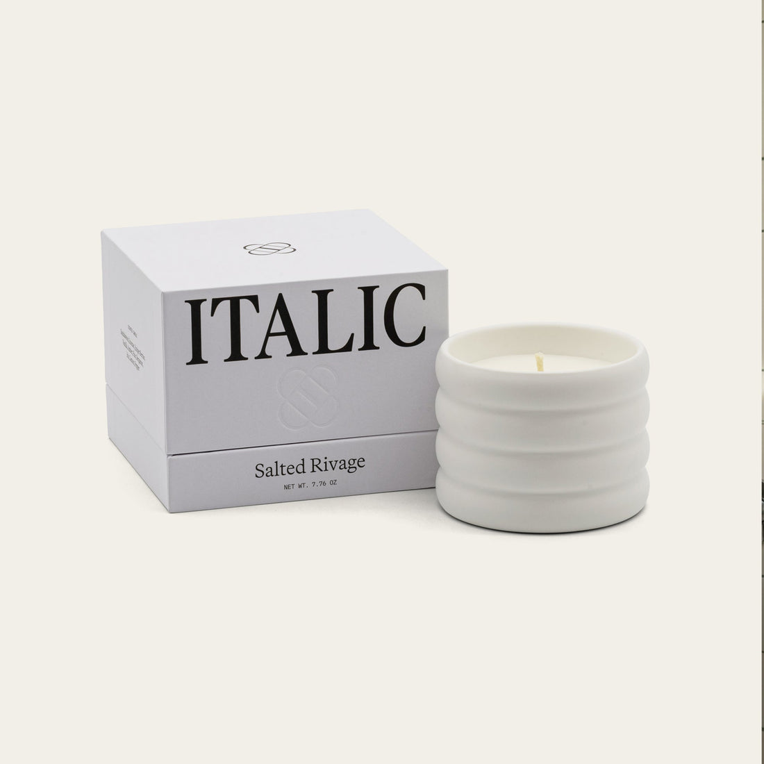 Soy wax ceramic candle by Italic with a salted scent, featuring a smooth ceramic holder and a lit wick for cozy ambiance.