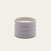 Lilac soy wax ceramic candle by Italic, showcasing a sleek ceramic container with a lit wick and soft candle glow.