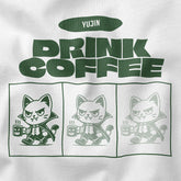 Yūjin Clothing Drink Coffee Cat T-Shirt featuring a playful cat graphic on a casual cotton t-shirt for coffee lovers.