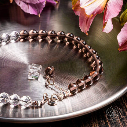 Silver Energy Shield Anklet by Conscious Items featuring a delicate chain and a small shield pendant around the ankle.