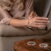 Conscious Items fertility bracelet featuring beads and charms designed to support fertility and wellness.