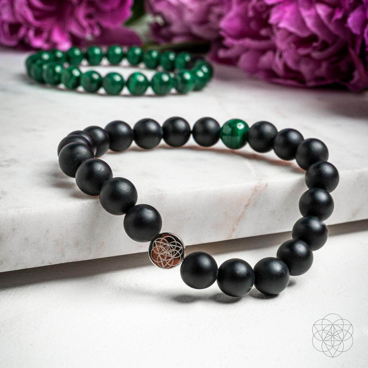 Two stylish bracelets from the Conscious Items Anxiety Double Bracelet Set, featuring calming design elements and adjustable fits.