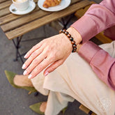 Mahogany Obsidian bracelet from Conscious Items featuring beads, worn as a stylish accessory for self-awareness and protection.